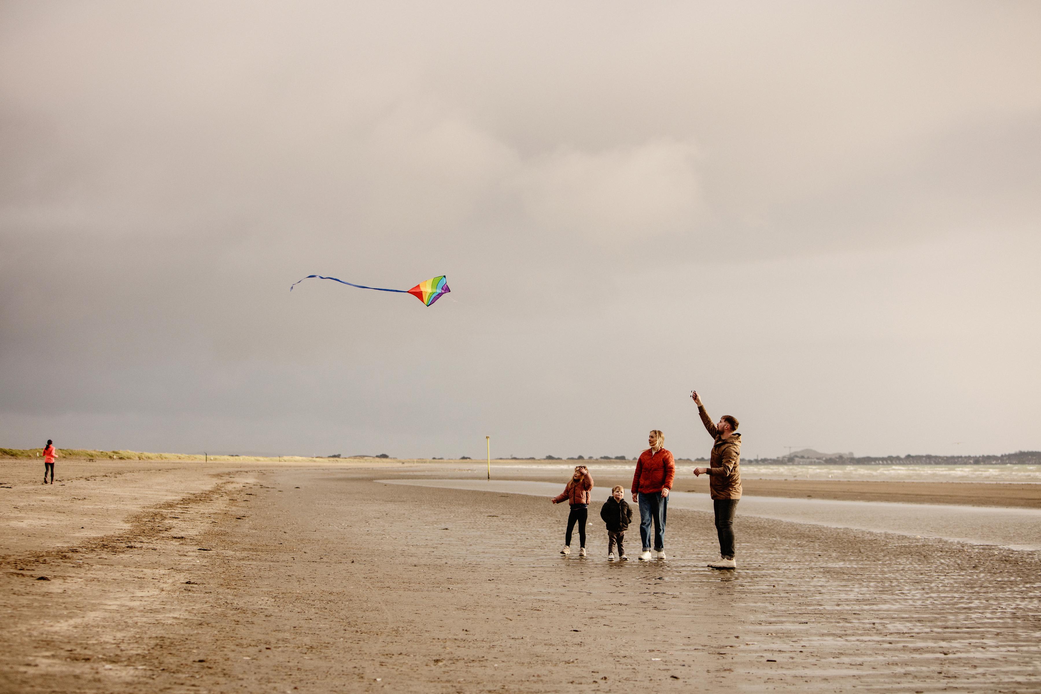 Image of a family flying a kite